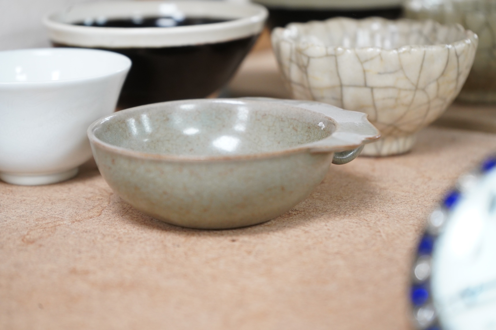 A collection of Chinese porcelain and pottery to include a naturalistic teapot, crackle glaze bowl and a ‘dragon’ bowl, largest 10cm in diameter